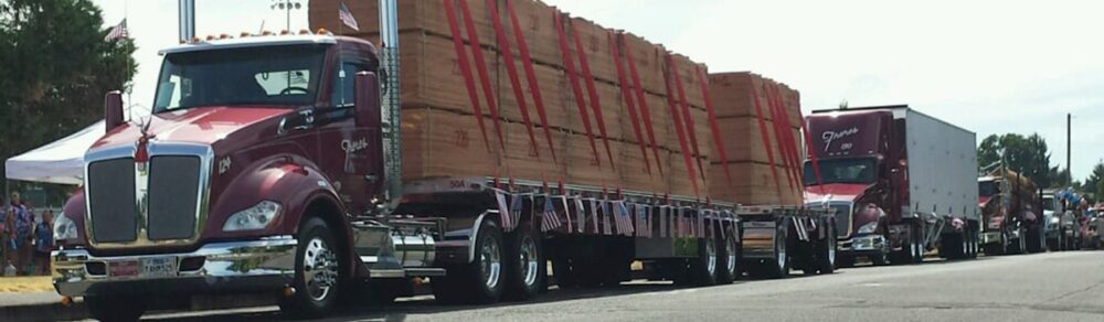 Freres Lumber trucks hauling plywood