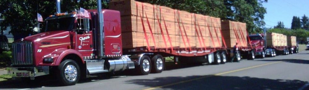 Freres Lumber trucks hauling plywood