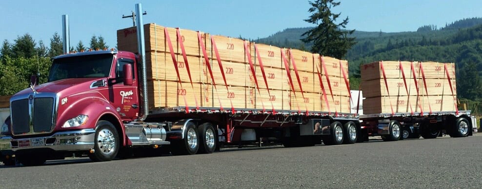 Freres Lumber trucks hauling plywood